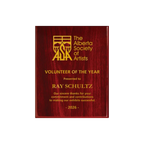 A photo of a Rosewood Piano Finish plaque with full laser engraved text and graphics, and colour fill.