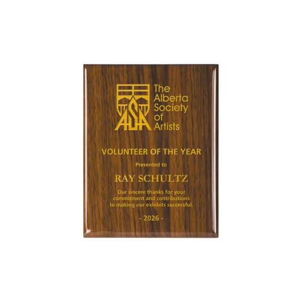 A photo of a Walnut Piano Finish plaque with full laser engraved text and graphics, and colour fill.