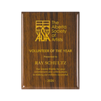 A photo of a Walnut Piano Finish plaque with full laser engraved text and graphics, and colour fill.