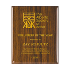A photo of a Walnut Piano Finish plaque with full laser engraved text and graphics, and colour fill.