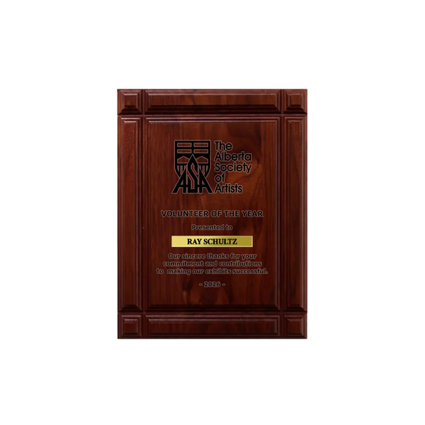 A photo of a solid wood Deep Groove Walnut plaque with a laser engrave text and graphics, and a traditional engraved name plate.