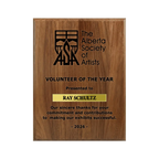 A photo of a solid wood traditional Walnut plaque with a laser engrave text and graphics, and a traditional engraved name plate.