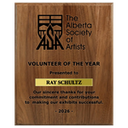 A photo of a solid wood traditional Walnut plaque with a laser engrave text and graphics, and a traditional engraved name plate.