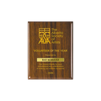 A photo of a Walnut Piano Finish plaque with a laser engrave text and graphics, and a traditional engraved name plate.