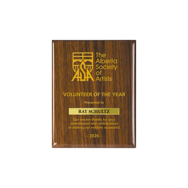 A photo of a Walnut Piano Finish plaque with a laser engrave text and graphics, and a traditional engraved name plate.