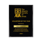 A photo of a Black Piano Finish plaque with a laser engrave text and graphics, and a traditional engraved name plate.