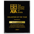 A photo of a Black Piano Finish plaque with a laser engrave text and graphics, and a traditional engraved name plate.