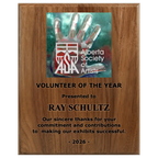 A photo of a solid wood traditional Walnut plaque with laser engraving on the bottom-half and full-colour plate on the top-half.