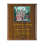 A photo of a Walnut Piano Finish plaque with a full-coloured plate on the top-half and laser engraving on the bottom-half.