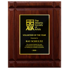 A photo of a solid wood Deep Groove Walnut plaque with a traditional engraved plate covering the plaque. 